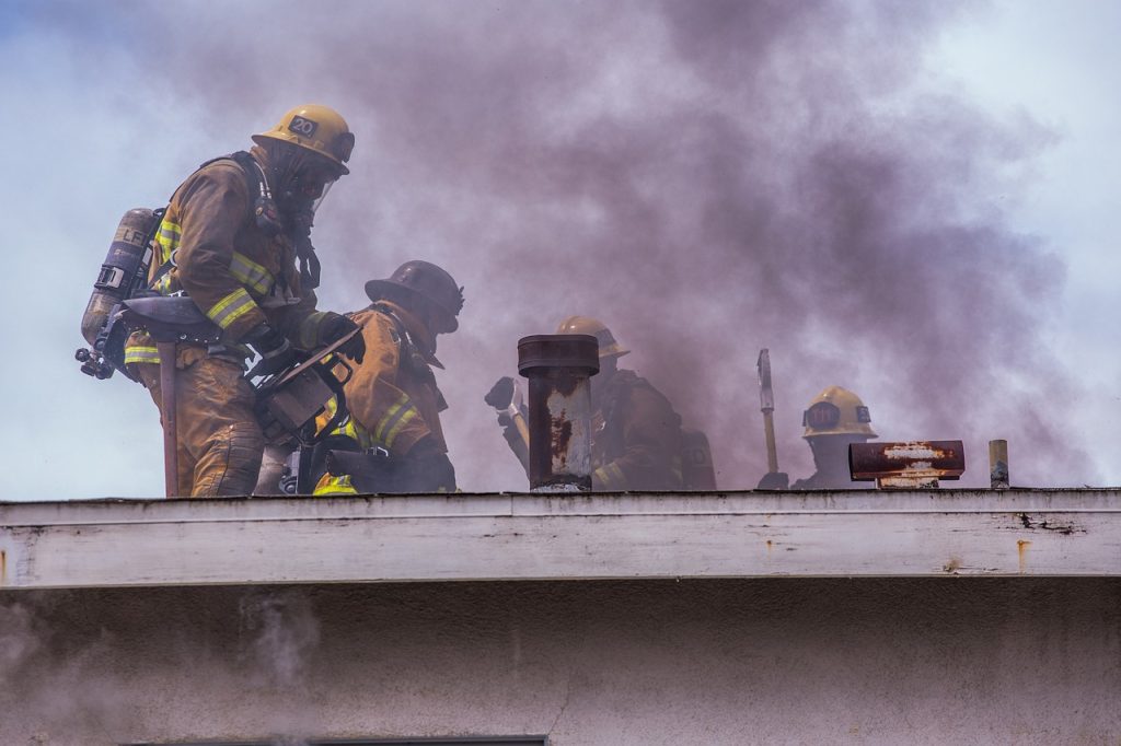 An image of a determined homeowner, surrounded by paperwork and filing cabinets, engaged in a phone call with a friendly insurance representative, showcasing their mutual understanding and collaborative efforts to navigate the complex fire insurance claim process successfully